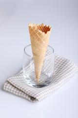 empty ice cream cone in clear glass on white background