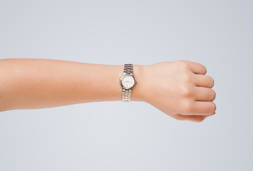 Hand with watch showing precise time