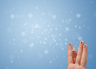 Happy finger smileys with empty blue bokeh background