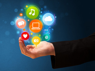 Multimedia icons in the hand of a businessman