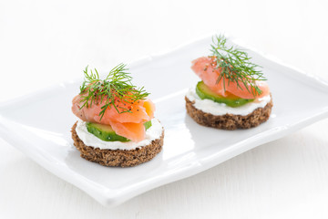 canape with cheese, cucumber and salted salmon