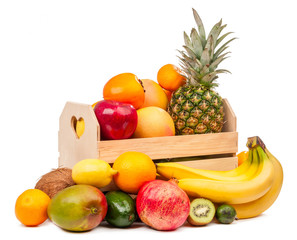 Composition of tropical fruits in a basket and near it isolated