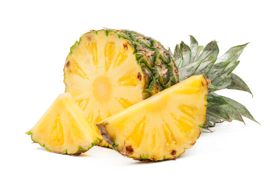 Half of pineapple and his slices isolated