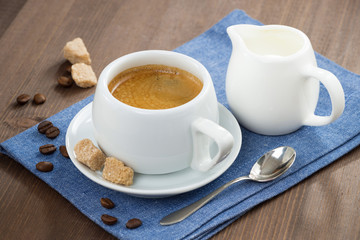 cup of espresso, sugar and jug of milk