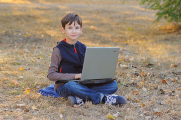 A Boy and a Laptop Outdoors