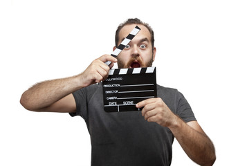 Casual young man holding a clapboard