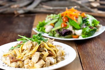 Chicken Pasta and Vegetable Salad Meal on Table