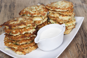 Vegetable fritters of zucchini with parsley and dill closeup  .