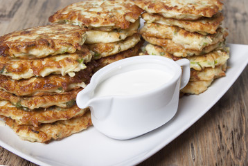 Vegetable fritters of zucchini with parsley and dill closeup  .