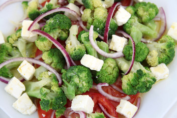 Close up of broccoli salad with tomatoes and cheese