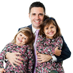 Young man in suit holding his two daughters.