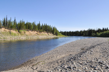 Pebbly shore of the river Kokpela.