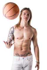 Long haired shirtless man with basketball ball