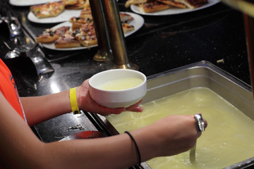 Person pouring broth