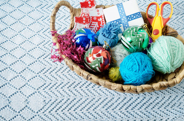 Skeins of yarn with Christmas balls in a basket