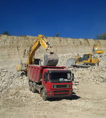 Loading of crushed stone in the truck excavator