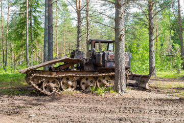 Old skidder at the forest in summertime