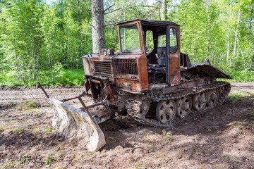 Old skidder at the forest in summertime