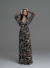 Full-length portrait of a sexy woman in elegant dress