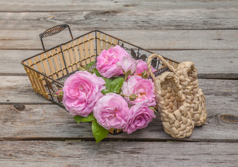 Bouquet of wild rose in vintage style on basket