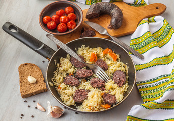 Black pudding with rice in a pan