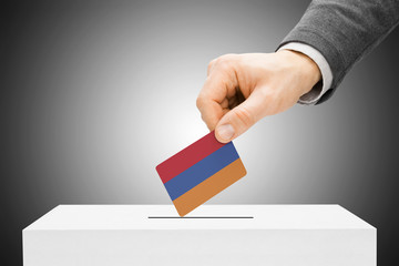 Voting concept - Male inserting flag into ballot box - Armenia