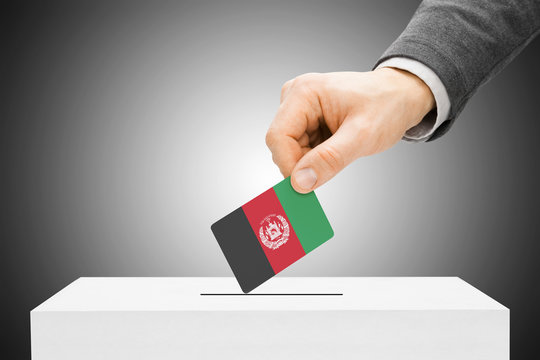 Male inserting flag into ballot box - Afghanistan