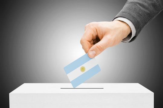 Voting concept - Male inserting flag into ballot box - Argentina