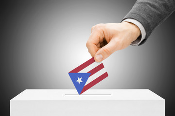 Male inserting flag into ballot box - Puerto Rico