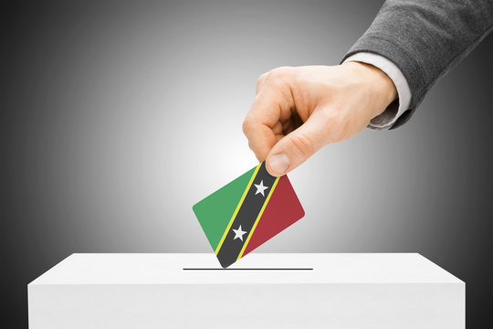 Male inserting flag into ballot box - Saint Kitts and Nevis