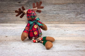Christmas reindeer toy on wooden background © olllinka2