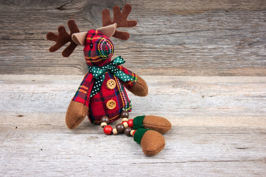 Christmas reindeer toy on wooden background