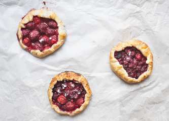 Small berry galettes on white paper