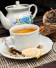Obraz na płótnie Canvas A cup of herbal tea with lemon and cinnamon