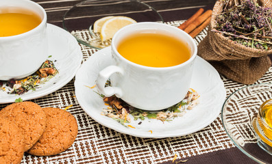 cup of herbal tea with cinnamon and oatmeal cookies