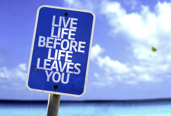 Live Life Before Life Leaves You sign with a beach