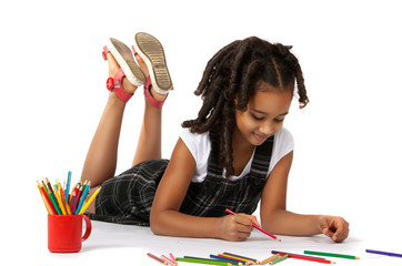 cheerful girl draws pencil lying on the floor