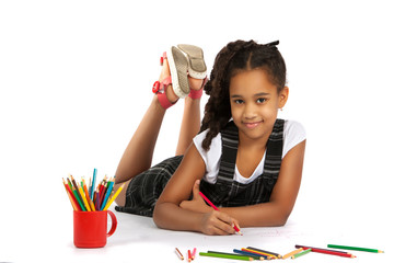 cheerful girl draws pencil lying on the floor