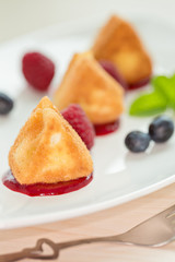 Fried camembert cheese with raspberry coulis and fresh berry for