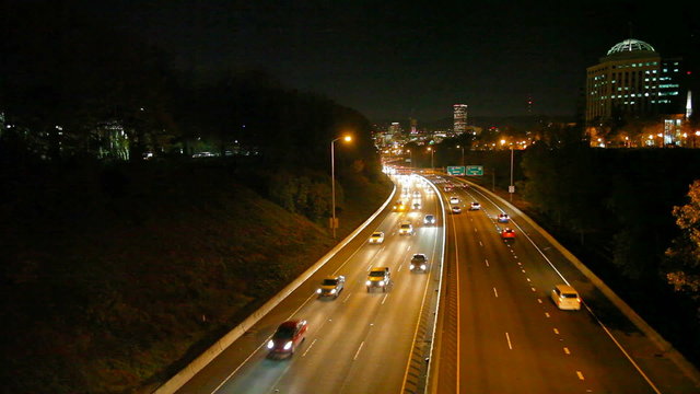 Traffic on I-84 Banfield Freeway with Portland Skyline at Night