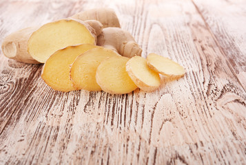 Ginger root sliced on wooden table