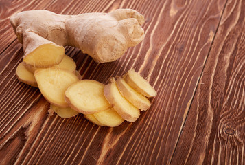Ginger root sliced on wooden table