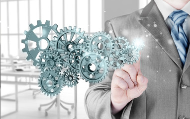 businessman hand touch  gear to success concept