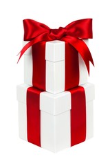 Two stacked white Christmas gift boxes with red bow and ribbon