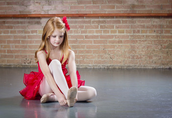 Beautiful young ballerina getting ready for class © Brocreative
