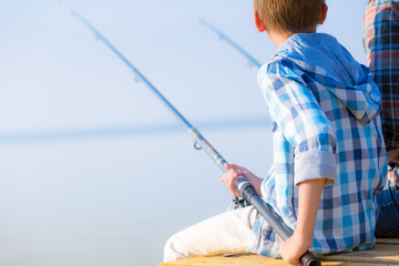 Close-up of hands of a boy with a fishing rod