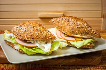 Sandwiches on a plate with wooden background