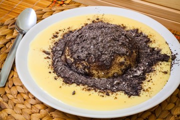 Austrian traditional dumpling with vanilla sauce and poppy