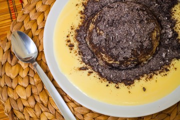 Austrian traditional dumpling with vanilla sauce and poppy