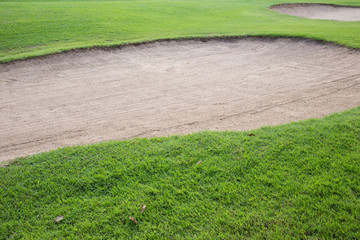 sand bunker and green grass of golf course